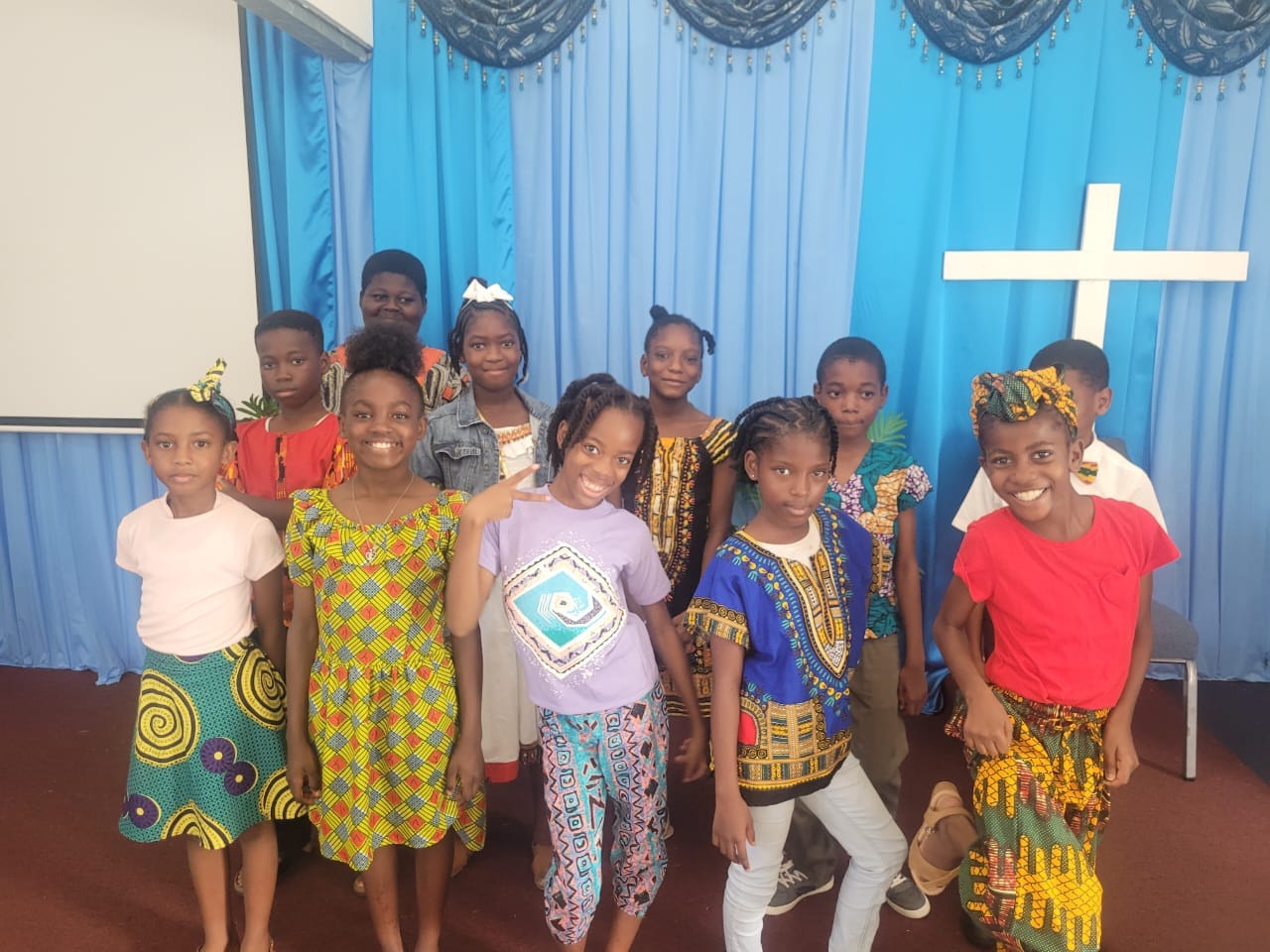 Children celebrating together in colorful cultural dress at church
